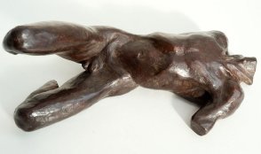 sinister lateral view of a sculpture of a male nude torso lying down