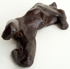 caudal lateral view of a sculpture of a male nude torso lying down