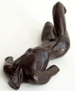 cranial lateral view of a sculpture of a male nude torso lying down