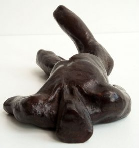cranial view of a sculputure of a male nude torso lying down
