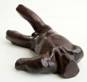 cranial view of a sculputure of a male nude torso lying down