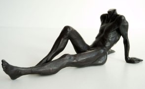 lateral frontal view of a bronze sculpture of a male nude sitting and leaning back on his arms