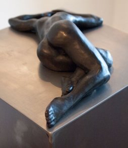 Bronze sculpture of a female nude lying down