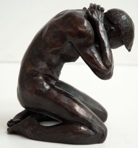 dexter lateral view of a bronze sculpture of a male nude kneeling down
