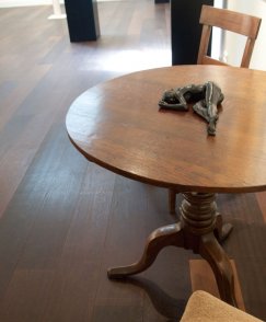 Bronze sculpture of a female nude lying on a table
