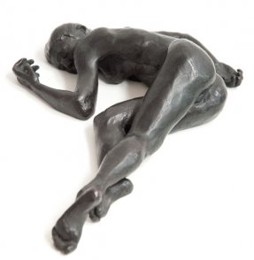 caudal frontal view of bronze sculpture of a female nude lying down