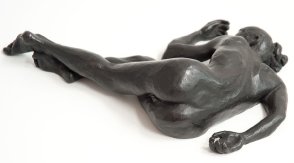 caudal dorsal view of bronze sculpture of a female nude lying down