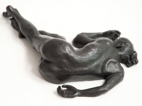 dorsal view of bronze sculpture of a female nude lying down