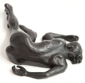dorsal view of bronze sculpture of a female nude lying down