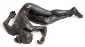 cranial view of bronze sculpture of a female nude lying down