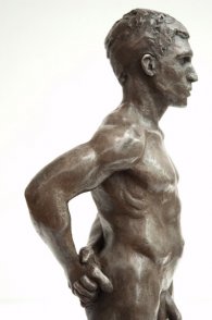 lateral view of trunk of bronze sculpture of male nude standing figure