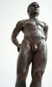 caudal frontal view of bronze sculpture of male nude standing figure