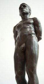 caudal frontal view of bronze sculpture of male nude standing figure
