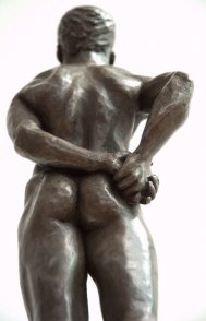 caudal dorsal view of bronze sculpture of male nude standing figure