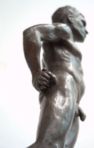 caudal lateral view of bronze sculpture of male nude standing figure