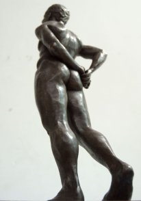 caudal lateral dorsal view of bronze sculpture of standing male nude figure