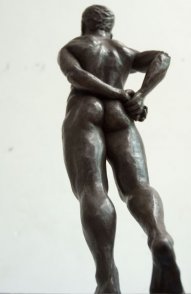 caudal dorsal lateral view of bronze sculpture of standing male nude figure