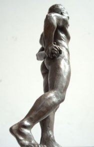 caudal lateral dorsal view of bronze sculpture of standing male nude figure