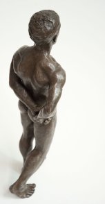cranial dorsal lateral view of bronze sculpture of male nude standing figure