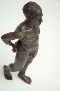 cranial lateral frontal view of bronze sculpture of male nude standing figure