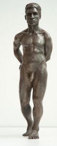 frontal view of bronze sculpture of male nude standing figure