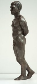 lateral frontal view of bronze sculpture of male nude standing figure