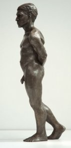 lateral view of bronze sculpture of male nude standing figure