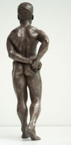 dorsal view of bronze sculpture of male nude standing figure