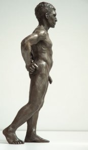 lateral dorsal view of bronze sculpture of male nude standing figure