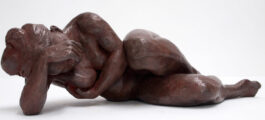 Bronze sculpture of a female nude resting on her elbow