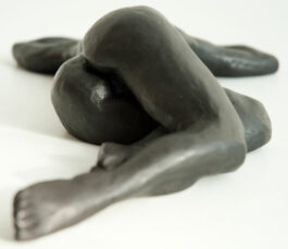 bronze sculpture of a female nude lying down