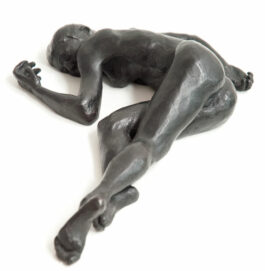 bronze sculpture of a female nude lying down