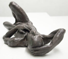 Bronze sculpture of a male nude man lying on his back with one knee up